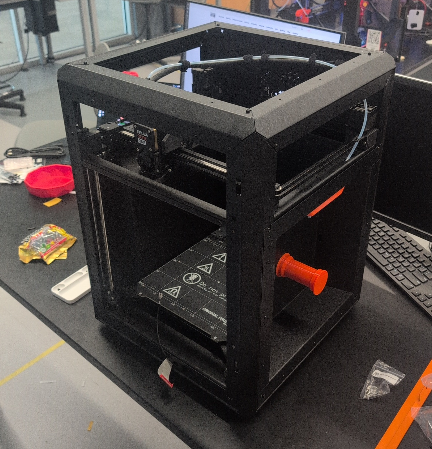 The Prusa Core One's orange handles.